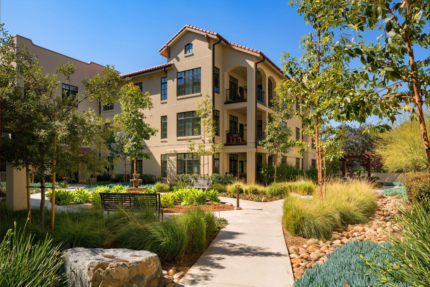 A senior living community exterior with landscaped courtyard